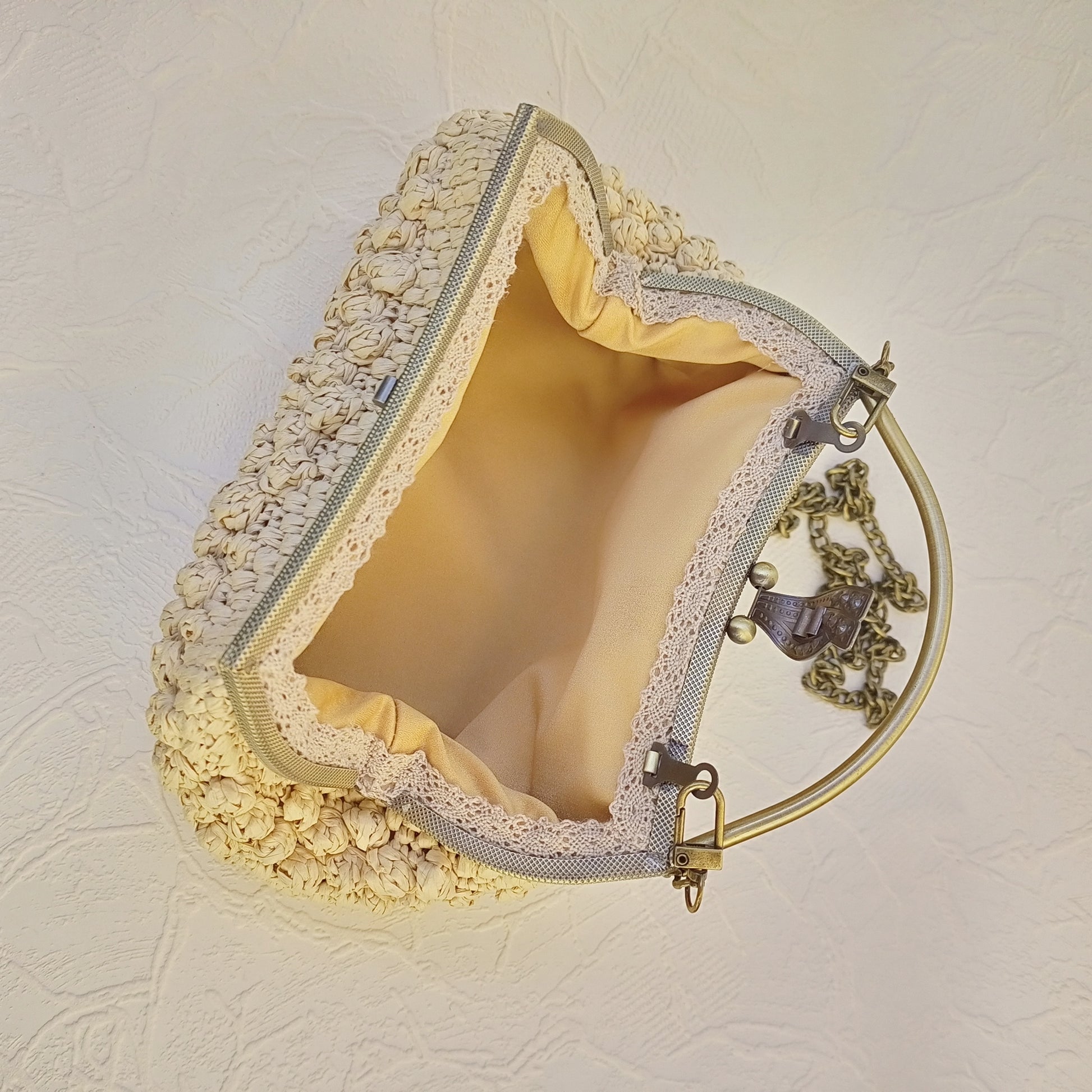 Interior cotton lining of beige crochet kisslock purse