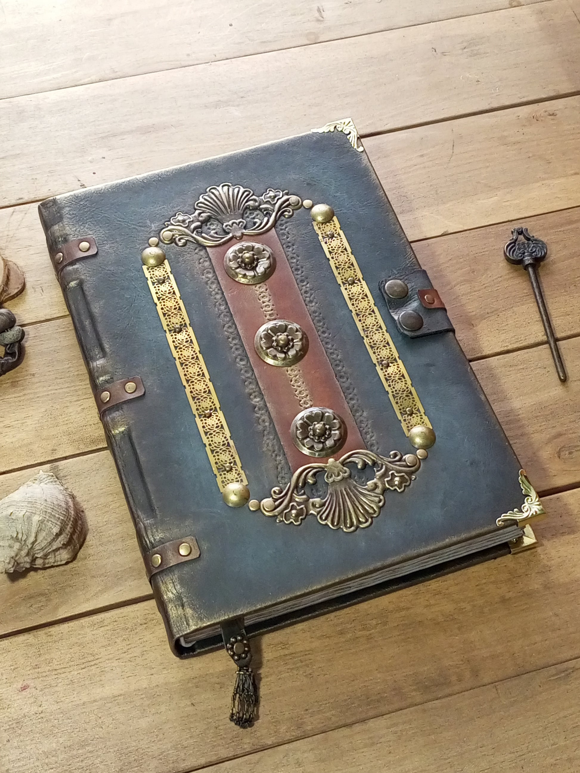 Medieval style aged gray leather journal with metal decorations