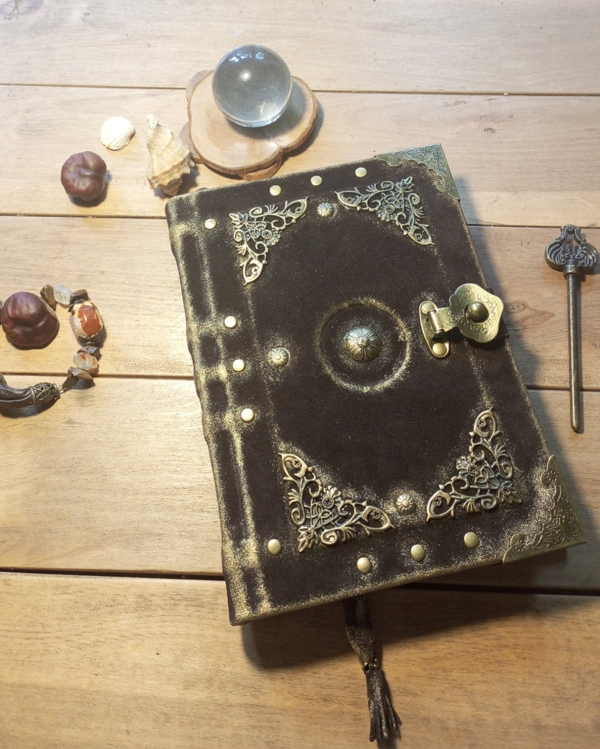 Aged brown suede leather-bound book with aged pages and brass embelishments and antique lock