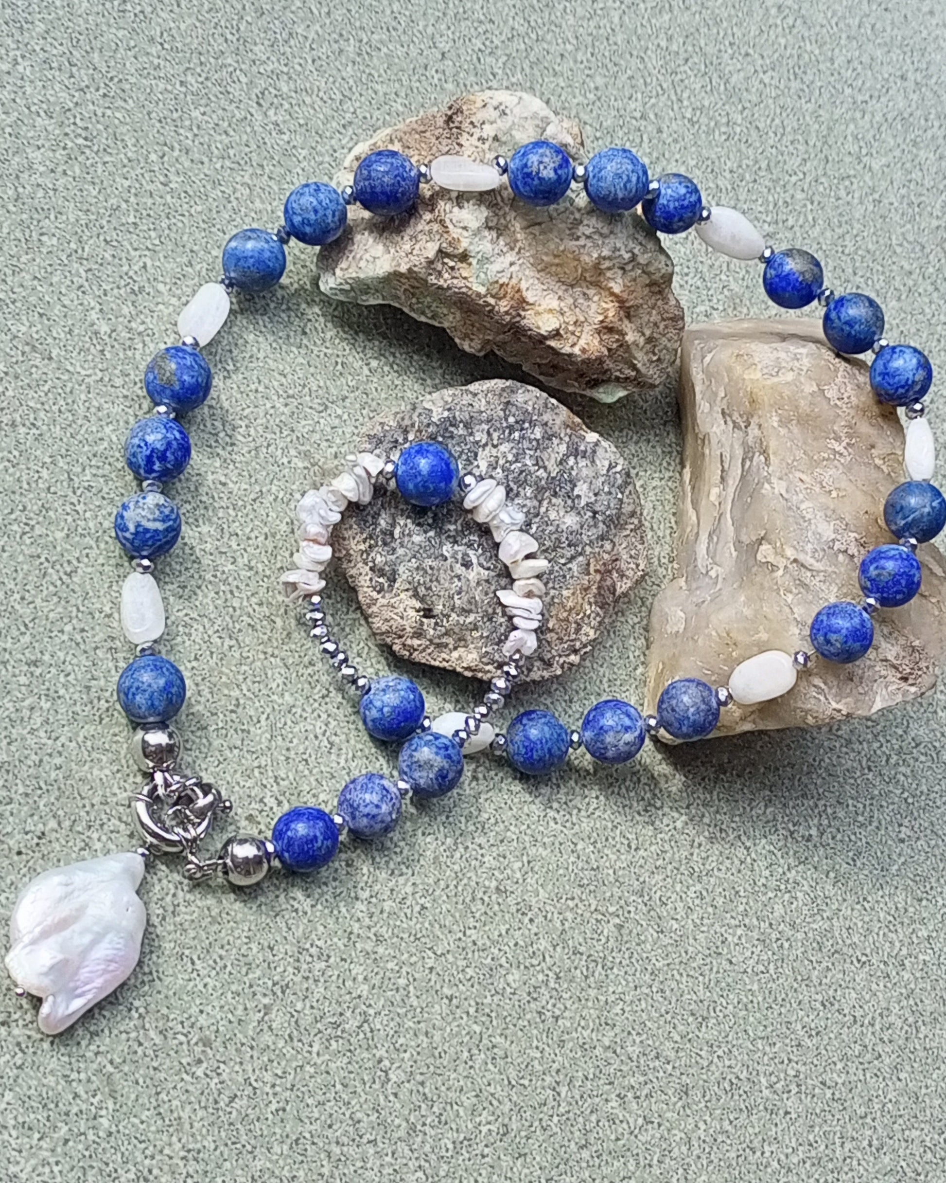 Beaded lapis lazuli necklace with blue and white beads and a baroque pearl charm 