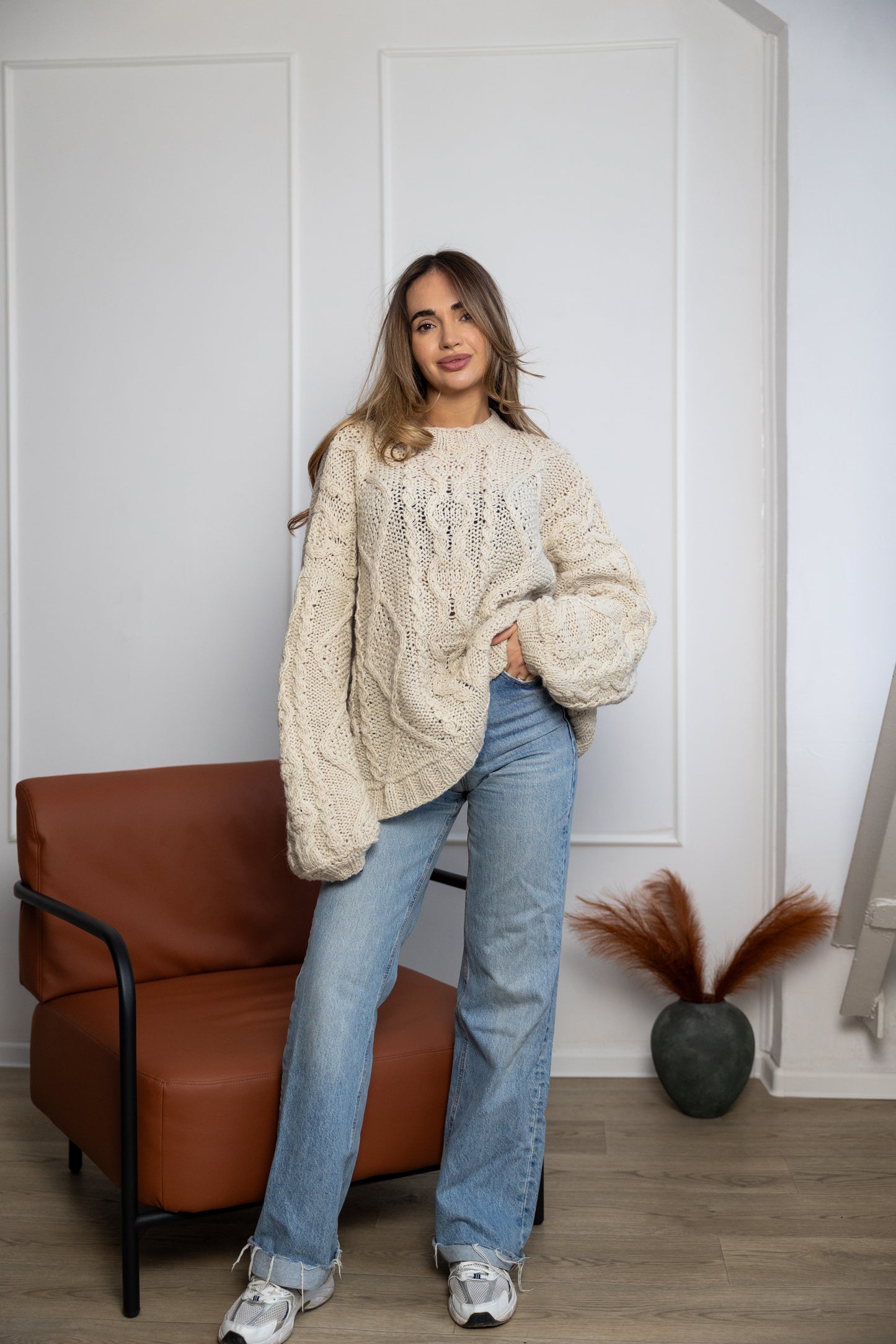 Cable knit texture detail on ivory handmade sweater