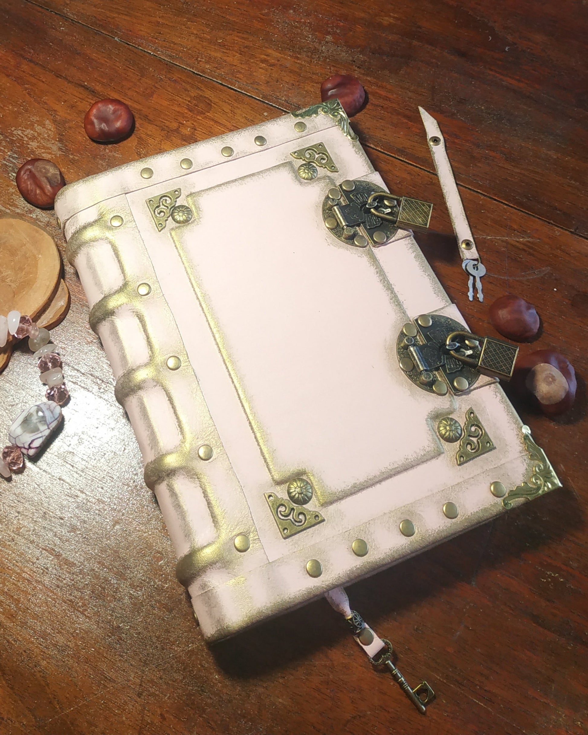 Aged pink leather bound journal with antique brass embelishments and locks