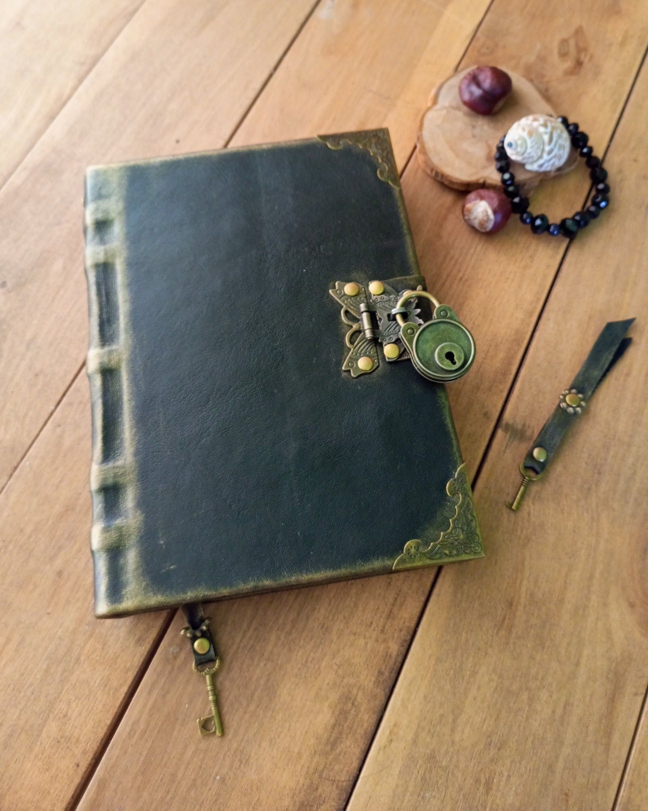 Vintage-style leather-bound book with decorative clasp on a wooden surface
