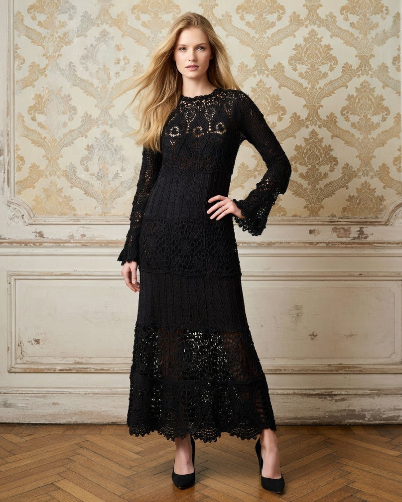 Woman wearing a black crochet lace maxi dress with long sleeves in an elegant room with ornate wall designs.
