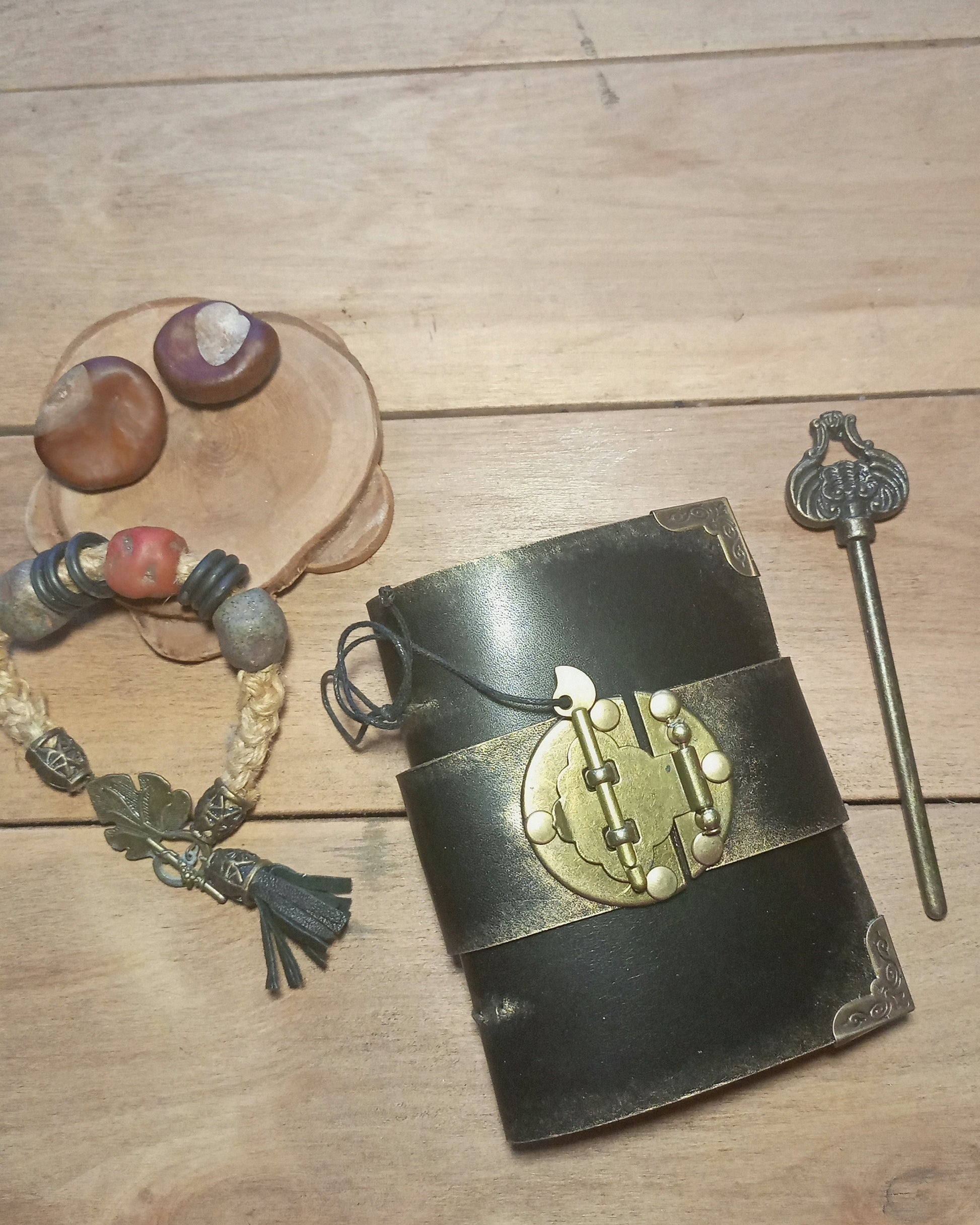 Vintage-style black leather notebook with brass lock, key