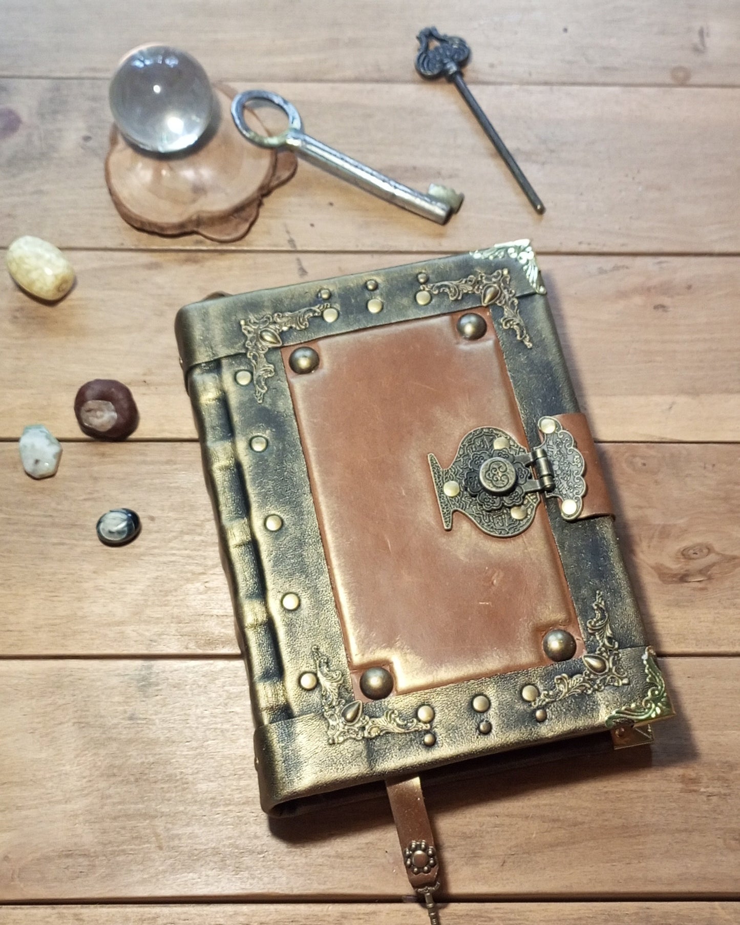 Decorative black-rusty leather-bound aged book with brass clasp 