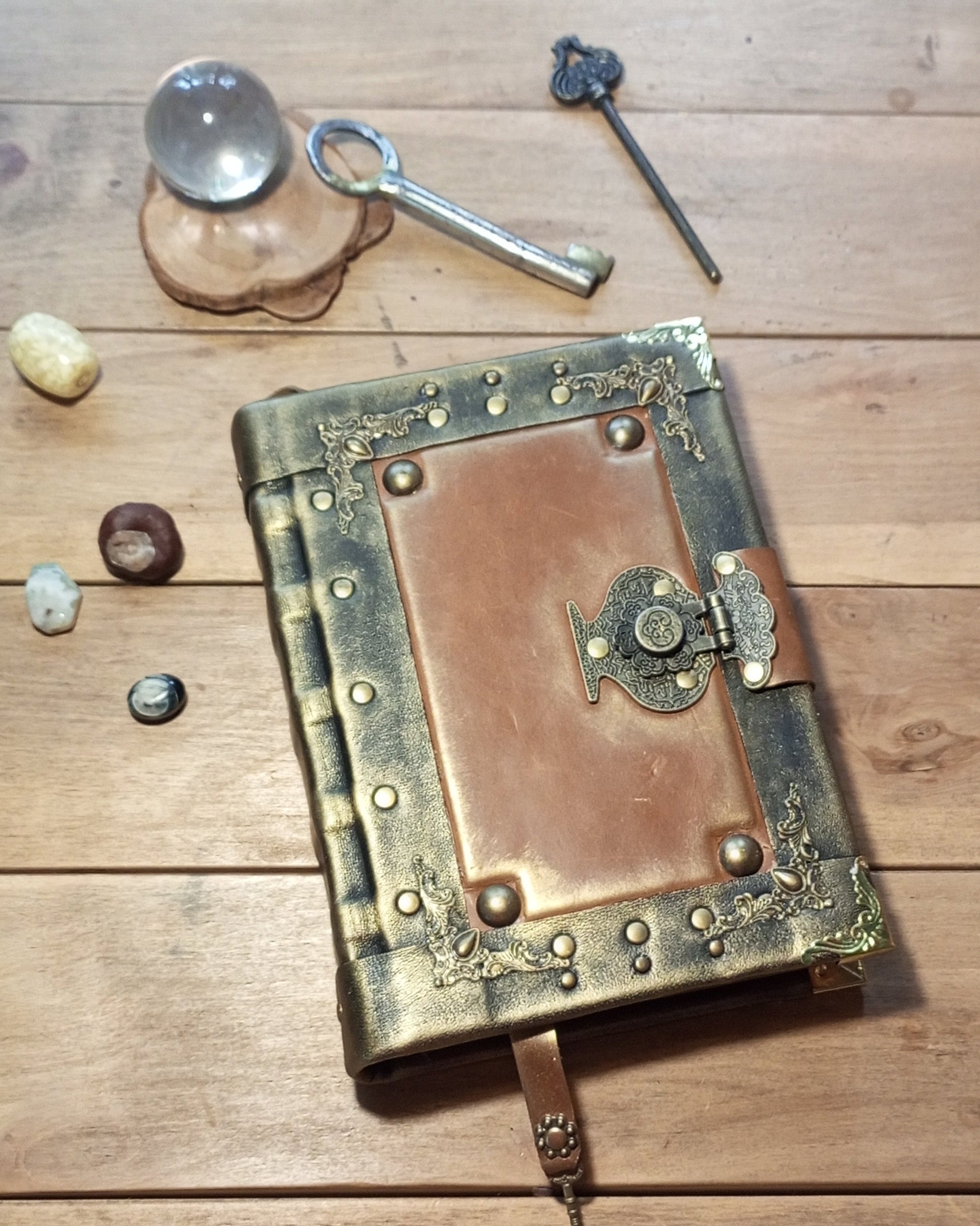 Decorative black-rusty leather-bound aged book with brass clasp 