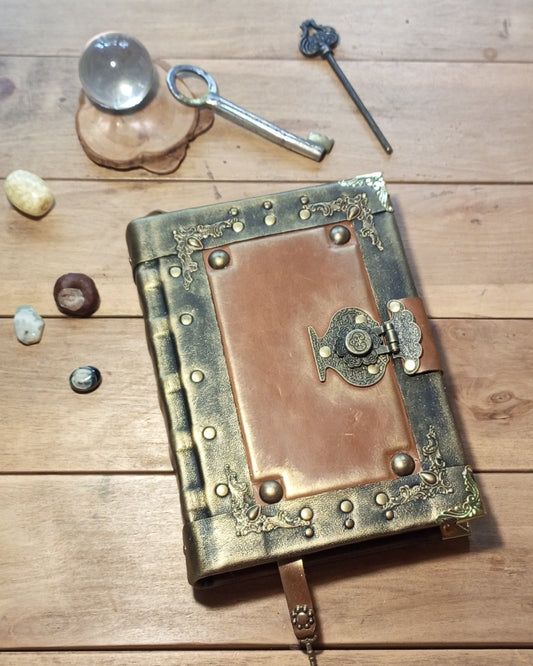 Decorative black-rusty leather-bound aged book with brass clasp 