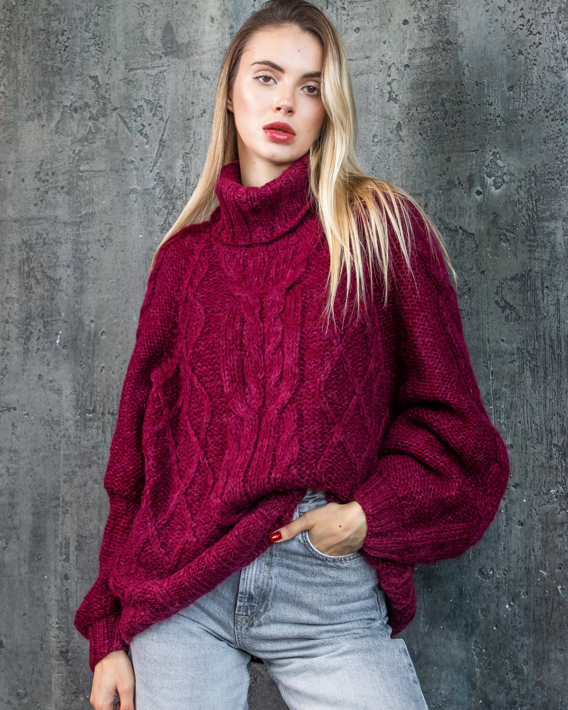 Woman wearing a handmade bordeaux oversize cable knit sweater