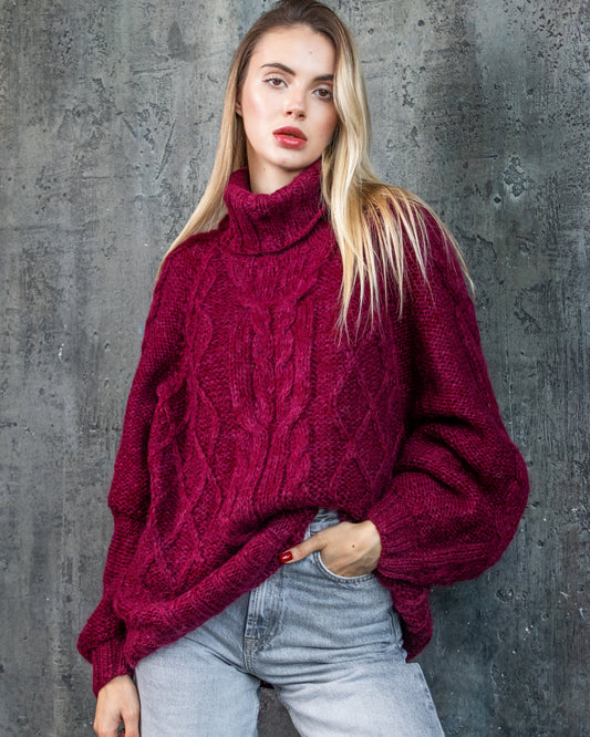 Woman wearing a handmade bordeaux oversize cable knit sweater