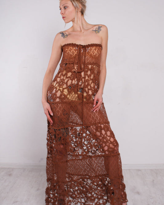 Woman wearing a brown crochet lace strapless dress 