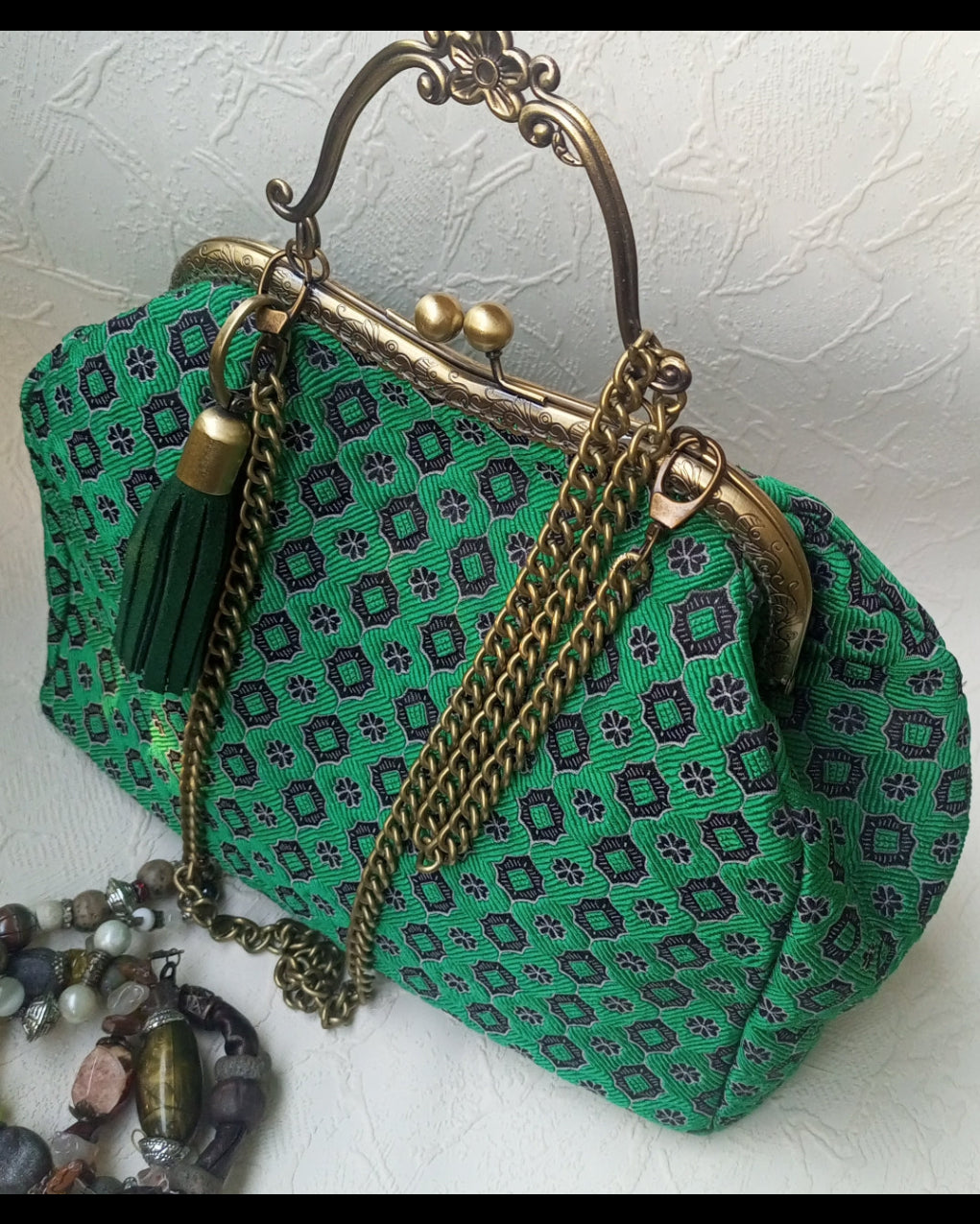 Green patterned jaccard kisslock handbag with gold chain and tassel 