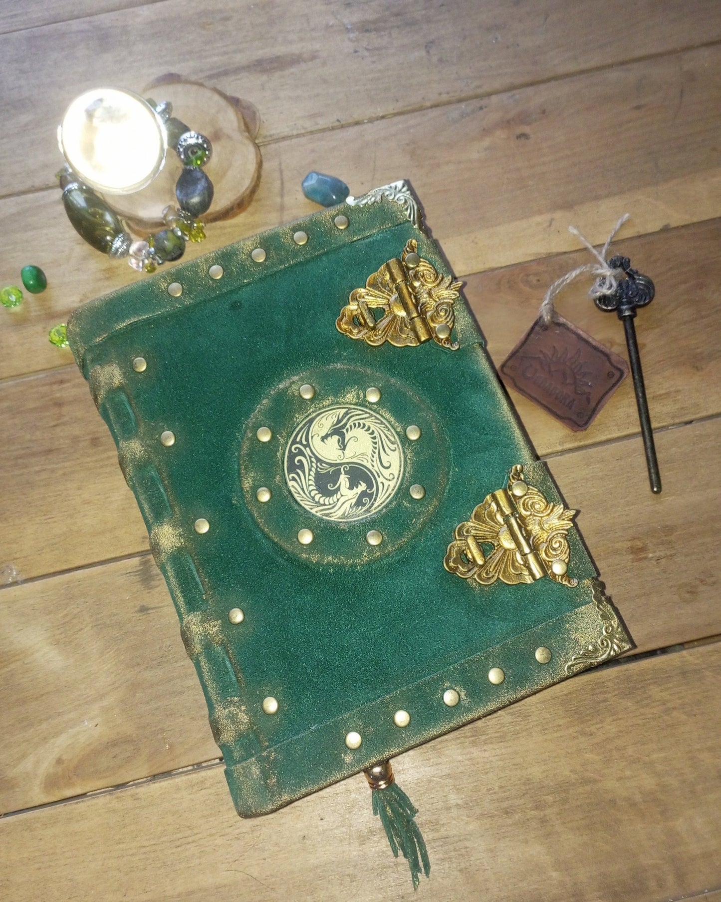 Emerald green suede aged grimoire with brass embelishments and yin-yang symbol