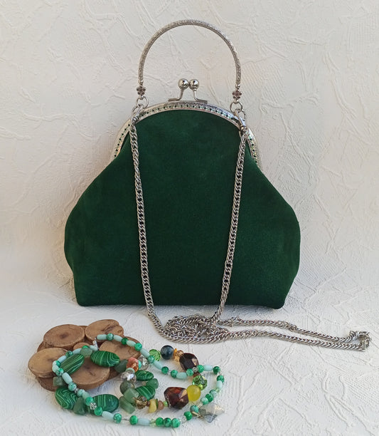 Emerald Green suede handbag with a chain strap and kisslock frame of silver color