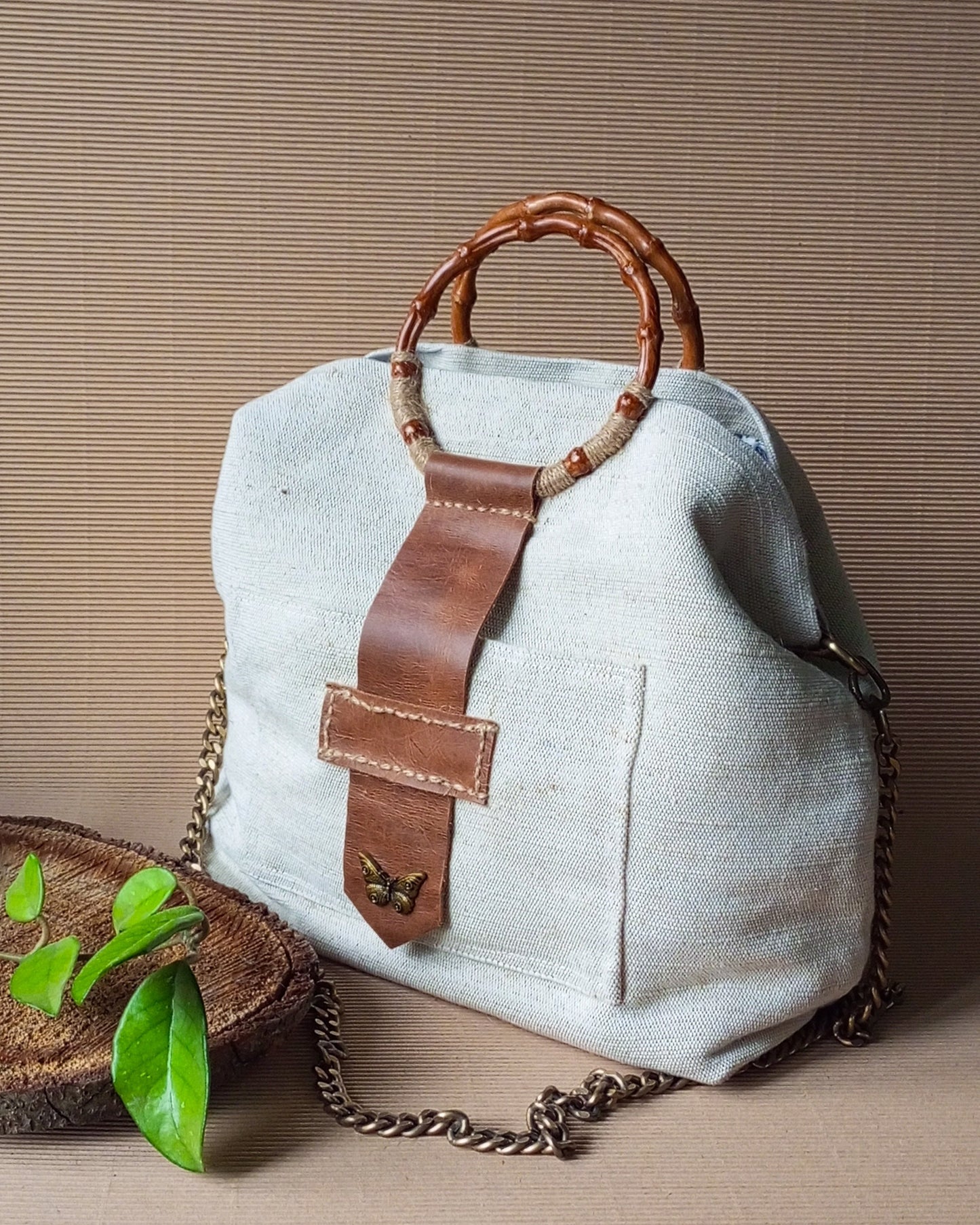 Ivory canvas tote bag with bamboo handles and leather details
