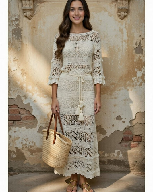 Woman wearing an ivory crochet maxi lace dress with long sleeves