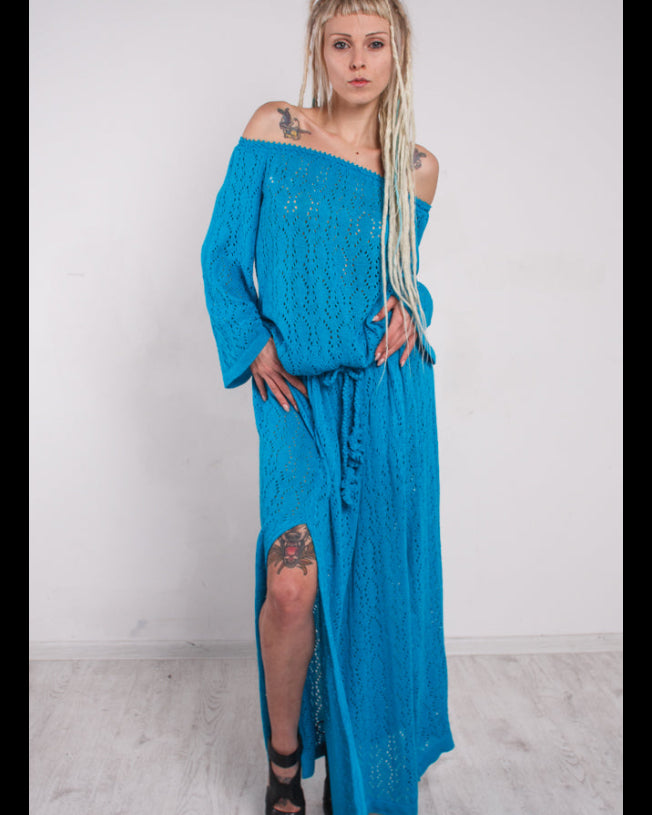 Woman wearing maxi knit lacy blue off-shoulder dress with slits