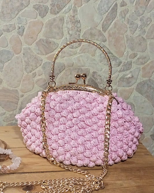 Pink crochet raffia handbag with gold removable chain and handle with kisslock frame