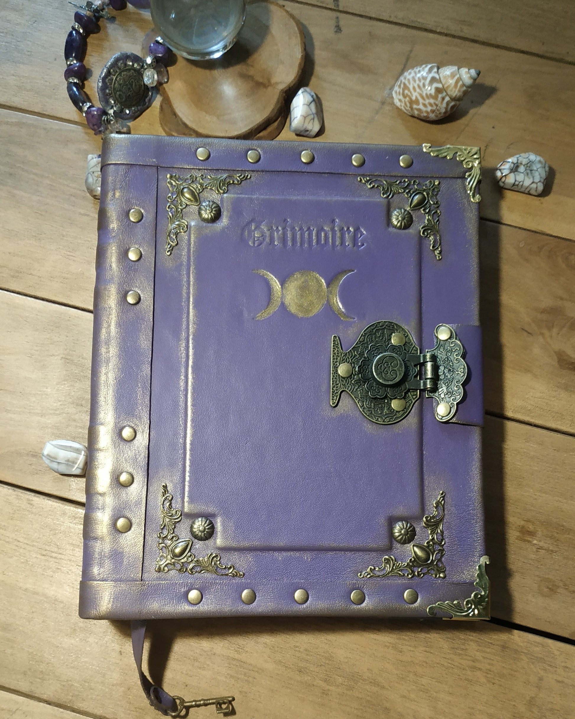 Purple book with gold embellishments on a wooden surface
