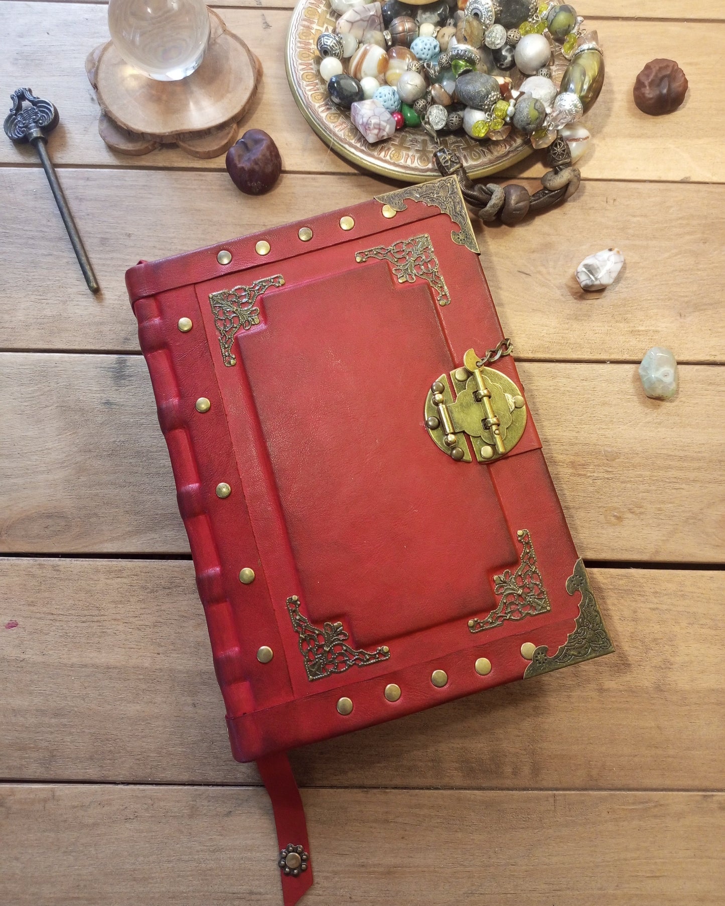 Aged leather red journal with brass metal embelishments and antique lock