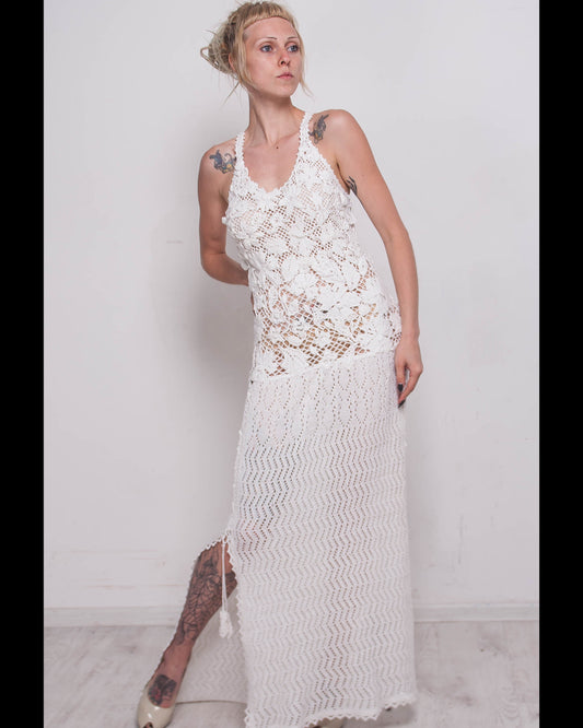 Woman wearing a crochet white maxi lace dress for resorts and weddings